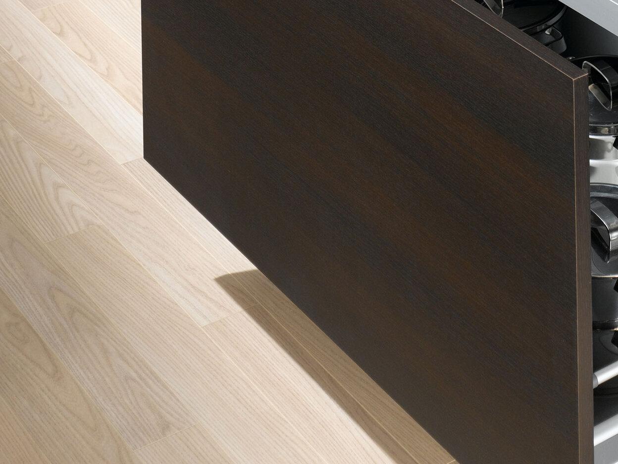 Detailaufnahme von Küchenschubladen mit viel Stauraum in dunklem Holz